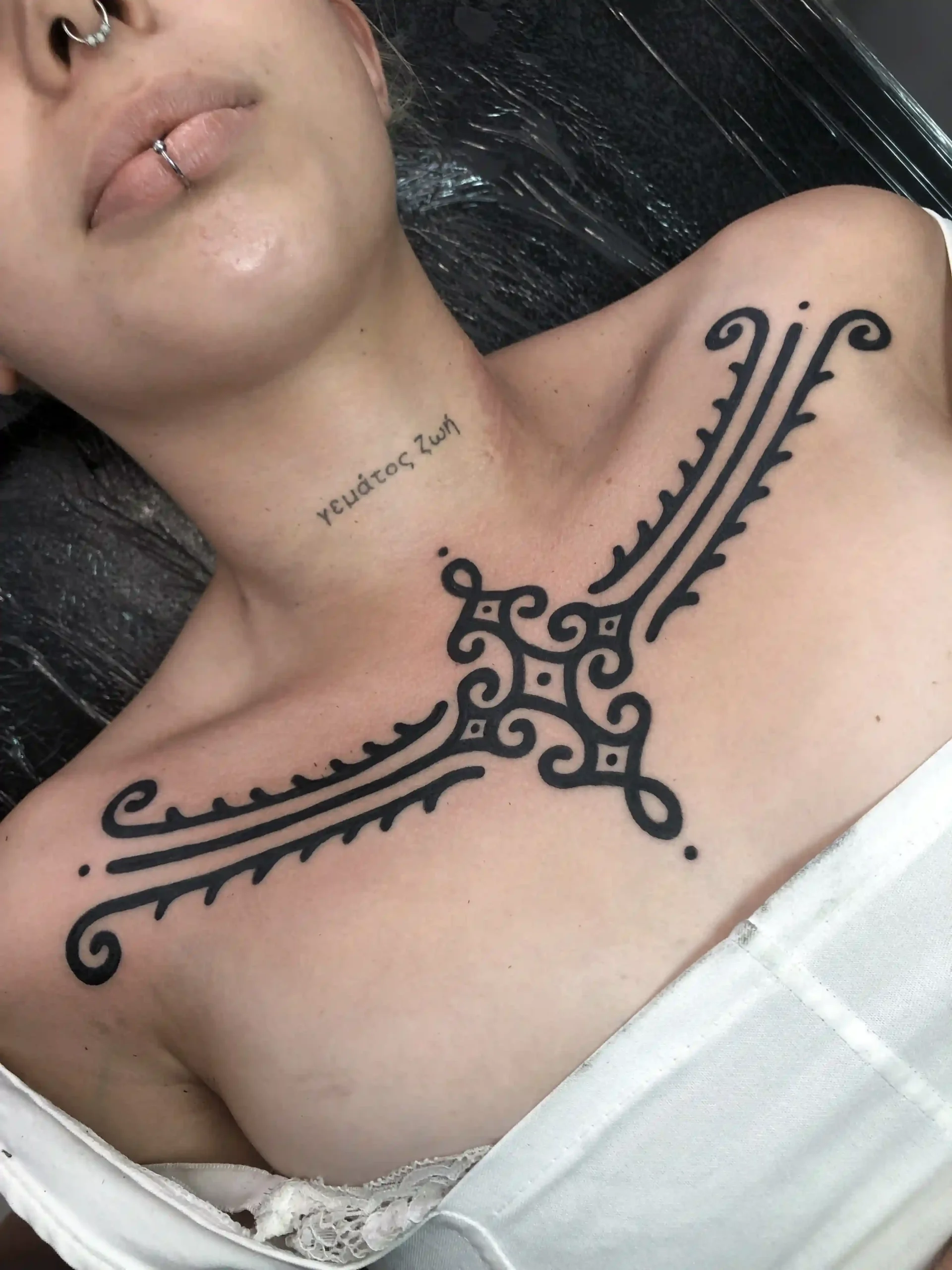 bold ornamental chest tattoo